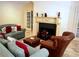Comfortable living room features decorative fireplace, tile flooring, and french doors at 9390 Colonnade Trl, Johns Creek, GA 30022