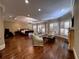 Spacious main bedroom boasts hardwood floors, a fireplace, and a sitting area with large windows at 9390 Colonnade Trl, Johns Creek, GA 30022