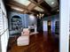 Cozy office with hardwood floors, custom bookshelves, a fireplace, and natural light at 9390 Colonnade Trl, Johns Creek, GA 30022