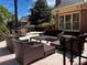 Beautiful brick patio featuring modern wicker furniture perfect for outdoor entertaining and relaxation at 9390 Colonnade Trl, Johns Creek, GA 30022