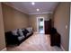 Cozy sitting room with a comfortable sofa, built-in shelving, and neutral color palette at 9390 Colonnade Trl, Johns Creek, GA 30022