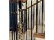 Close-up of elegant staircase with black iron spindles and a golden maiden statue at 9390 Colonnade Trl, Johns Creek, GA 30022