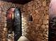 Ornate wrought iron door leads to the stone wine cellar at 9390 Colonnade Trl, Johns Creek, GA 30022