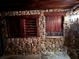 Rustic wine cellar with stacked stone walls, wooden shelving, and a stone countertop, perfect for the whiskey enthusiast at 9390 Colonnade Trl, Johns Creek, GA 30022