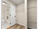 Hallway view of bathroom with white fixtures and shelving at 1371 Branch Dr, Tucker, GA 30084