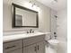 Modern bathroom featuring a gray vanity and marble tiled shower at 1371 Branch Dr, Tucker, GA 30084