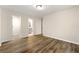 Bedroom with wood floors and multiple doorways providing access to other rooms at 1371 Branch Dr, Tucker, GA 30084
