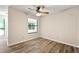 Cozy bedroom features a window, neutral paint, and wood-look flooring at 1371 Branch Dr, Tucker, GA 30084