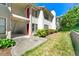Charming condo building with red doors, lush landscaping, and a well-maintained lawn at 1371 Branch Dr, Tucker, GA 30084