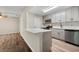 Bright kitchen features gray cabinets, stainless steel appliances, modern backsplash, and a functional center island at 1371 Branch Dr, Tucker, GA 30084