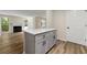 Open kitchen with island, views to the living area, and wood-look floors at 1371 Branch Dr, Tucker, GA 30084