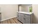 Kitchen island features quartz countertop and gray cabinets with black pulls at 1371 Branch Dr, Tucker, GA 30084