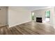 Bright living room with neutral paint, wood-look flooring, fireplace, and large windows at 1371 Branch Dr, Tucker, GA 30084