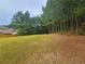 Picturesque backyard with mature trees and lush lawn, perfect for outdoor activities at 1750 Stone Meadow Rd, Lithonia, GA 30058