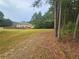 Expansive backyard with lush greenery and tree line at 1750 Stone Meadow Rd, Lithonia, GA 30058