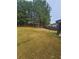 Backyard is spacious and grassy with a fence and mature trees visible on the left at 1750 Stone Meadow Rd, Lithonia, GA 30058