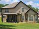 Covered patio and back of house offers a great space for relaxation or entertaining, with a well-maintained lawn at 1750 Stone Meadow Rd, Lithonia, GA 30058