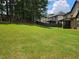 View of the spacious backyard with lush green grass, providing ample space for outdoor activities and relaxation at 1750 Stone Meadow Rd, Lithonia, GA 30058