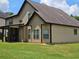 Exterior view of home's backyard with siding, dark trim, covered porch, and a lawn at 1750 Stone Meadow Rd, Lithonia, GA 30058