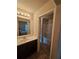 Bathroom with vanity, framed mirror, lighting, and shower/tub in background at 1750 Stone Meadow Rd, Lithonia, GA 30058