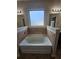 Soaking tub with tile surround and rectangular window at 1750 Stone Meadow Rd, Lithonia, GA 30058