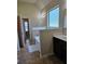 Bright bathroom featuring a soaking tub, ceramic tile, and a large window for natural light at 1750 Stone Meadow Rd, Lithonia, GA 30058