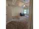 Spacious bedroom featuring plush carpet, a ceiling fan, and a cozy seating area at 1750 Stone Meadow Rd, Lithonia, GA 30058