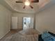 A spacious bedroom is accented with a tray ceiling and ceiling fan fixture at 1750 Stone Meadow Rd, Lithonia, GA 30058