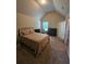 Spacious bedroom with tan carpet, large bed and natural light from the window at 1750 Stone Meadow Rd, Lithonia, GA 30058