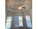 Bedroom featuring tray ceiling and windows at 1750 Stone Meadow Rd, Lithonia, GA 30058