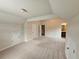 A carpeted bonus room with neutral walls, natural light, and a door to the bathroom at 1750 Stone Meadow Rd, Lithonia, GA 30058
