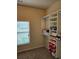 Closet featuring shelving, a window, and plush neutral carpet at 1750 Stone Meadow Rd, Lithonia, GA 30058