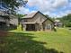 A view of the rear exterior highlighting the covered patio area perfect for outdoor entertaining and relaxing at 1750 Stone Meadow Rd, Lithonia, GA 30058