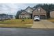 Charming two-story brick home with a well-manicured lawn and two-car garage at 1750 Stone Meadow Rd, Lithonia, GA 30058