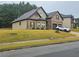 Charming brick and tan two-story home with a two-car garage and well-maintained lawn at 1750 Stone Meadow Rd, Lithonia, GA 30058