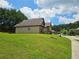 Spacious home with manicured lawn and mature trees, showcasing backyard at 1750 Stone Meadow Rd, Lithonia, GA 30058