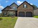 Charming two-story brick home with a well-manicured lawn and two-car garage at 1750 Stone Meadow Rd, Lithonia, GA 30058