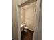 Convenient half bathroom featuring toilet and sink with wood-look floor at 1750 Stone Meadow Rd, Lithonia, GA 30058