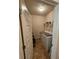 A view of the laundry room showing a white washer, dryer, and wire shelving for storage at 1750 Stone Meadow Rd, Lithonia, GA 30058
