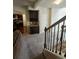 Open living area with built in cabinets and stairs with wrought iron railings at 1750 Stone Meadow Rd, Lithonia, GA 30058