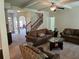 Open-concept living room boasts stylish furnishings, a ceiling fan, and staircase access at 1750 Stone Meadow Rd, Lithonia, GA 30058