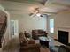 Comfortable living room features a ceiling fan, fireplace, and plenty of natural light at 1750 Stone Meadow Rd, Lithonia, GA 30058