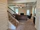 Cozy living room with fireplace, coffered ceilings, and staircase to the upper level at 1750 Stone Meadow Rd, Lithonia, GA 30058