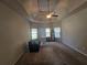 The spacious main bedroom features a tray ceiling, ceiling fan, and large windows at 1750 Stone Meadow Rd, Lithonia, GA 30058