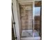 Glass enclosed shower with chrome fixtures and neutral tile surround at 1750 Stone Meadow Rd, Lithonia, GA 30058