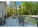 Backyard deck, furniture, outdoor dining area, and views of a lush yard and fire pit at 1953 Windcrest Sw Dr, Lilburn, GA 30047