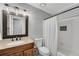 Charming bathroom with granite countertop, updated fixtures, and shower-tub combo at 1953 Windcrest Sw Dr, Lilburn, GA 30047