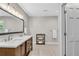 Bathroom with double sink vanity, towel rack, and wood-style tile flooring at 1953 Windcrest Sw Dr, Lilburn, GA 30047