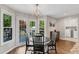 Eat-in kitchen features a modern light fixture, black round table and access to the outdoor deck at 1953 Windcrest Sw Dr, Lilburn, GA 30047