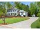 Spacious home featuring an attached garage, long driveway and a well-maintained lawn with mature landscaping at 1953 Windcrest Sw Dr, Lilburn, GA 30047
